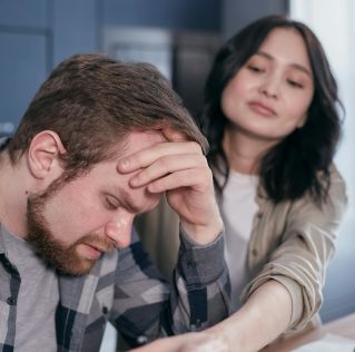 A couple experiencing stress and emotional distress at home, conveying empathy and support.